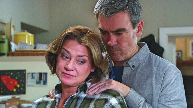 Cain puts his hands on wife Moira's shoulders in Emmerdale
