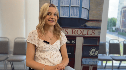 Sydney Martin smiles during a Coronation Street interview with Metro.co.uk about Betsy Swain