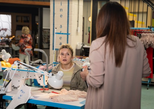 Betsy looks annoyed with Carla in the factory in Coronation Street