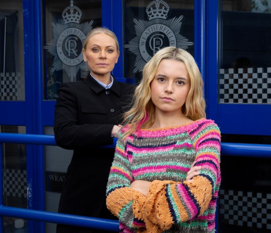 DS Swain and Betsy pose together outside the Coronation Street police station, with Betsy looking moody